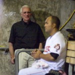 Fresno Grizzlies President Chris Cummings (left) has a discussion with Grizzlies pitcher Yusmeiro Petit in the dugout during Thursday night’s game.