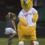 A child is entertained by Grizzlies mascot Parker in between innings.