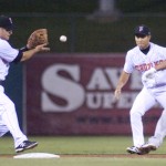 No. 26 of the Fresno Grizzlies Carter Jurica is about to tag out no. 14 of the Tacoma Rainiers Eric Thames at second base.